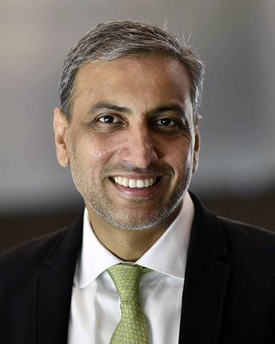 Headshot of Ankur Srivastava, a smiling man wearing a suit