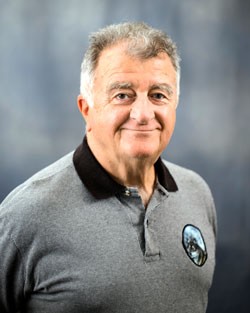 Headshot of Anthony Ephremides, a man smiling wearing a gray polo shirt