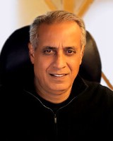 Headshot of Buno Pati, a man smiling and wearing a dark shirt